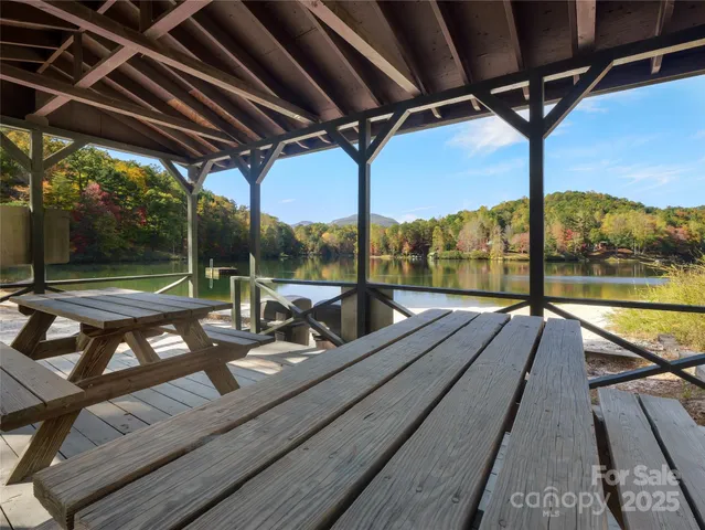 a view of a balcony with chairs and wooden floor