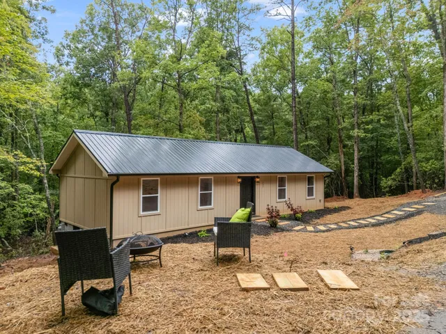 a backyard of a house with table and chairs