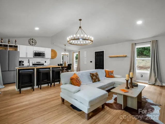 a living room with fireplace furniture and a wooden floor
