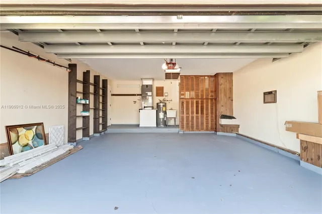 a view of empty room with a fireplace and chandelier