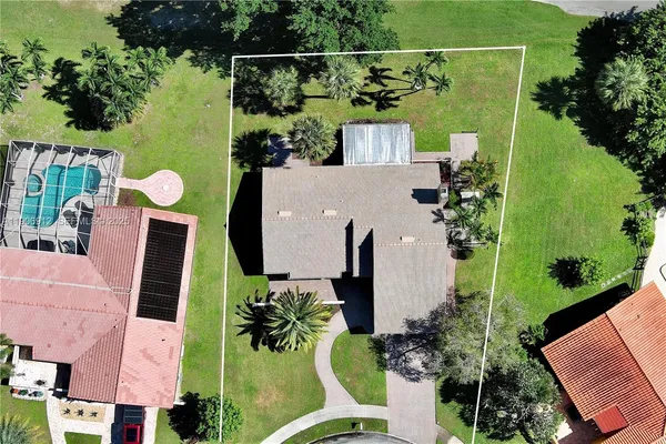 an aerial view of residential houses with outdoor space and street view