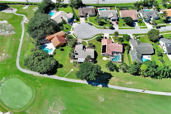 an aerial view of a house with yard swimming pool and outdoor seating