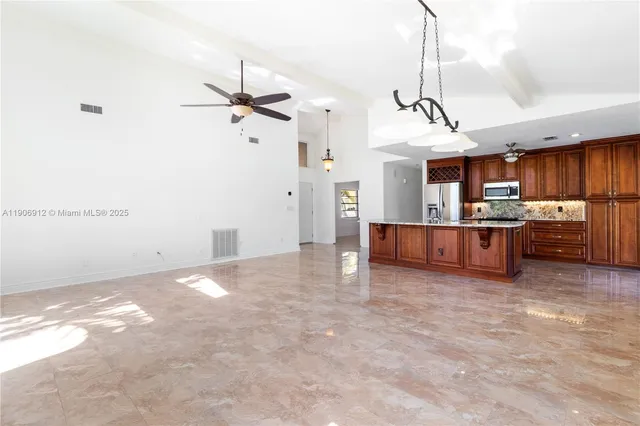 a view of a kitchen with a sink and cabinets