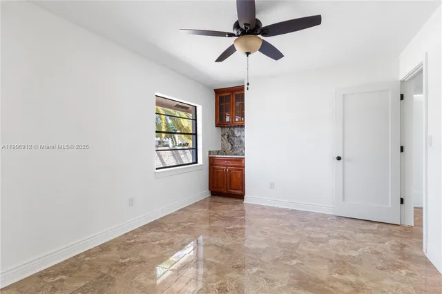 a view of a livingroom with a ceiling fan and window