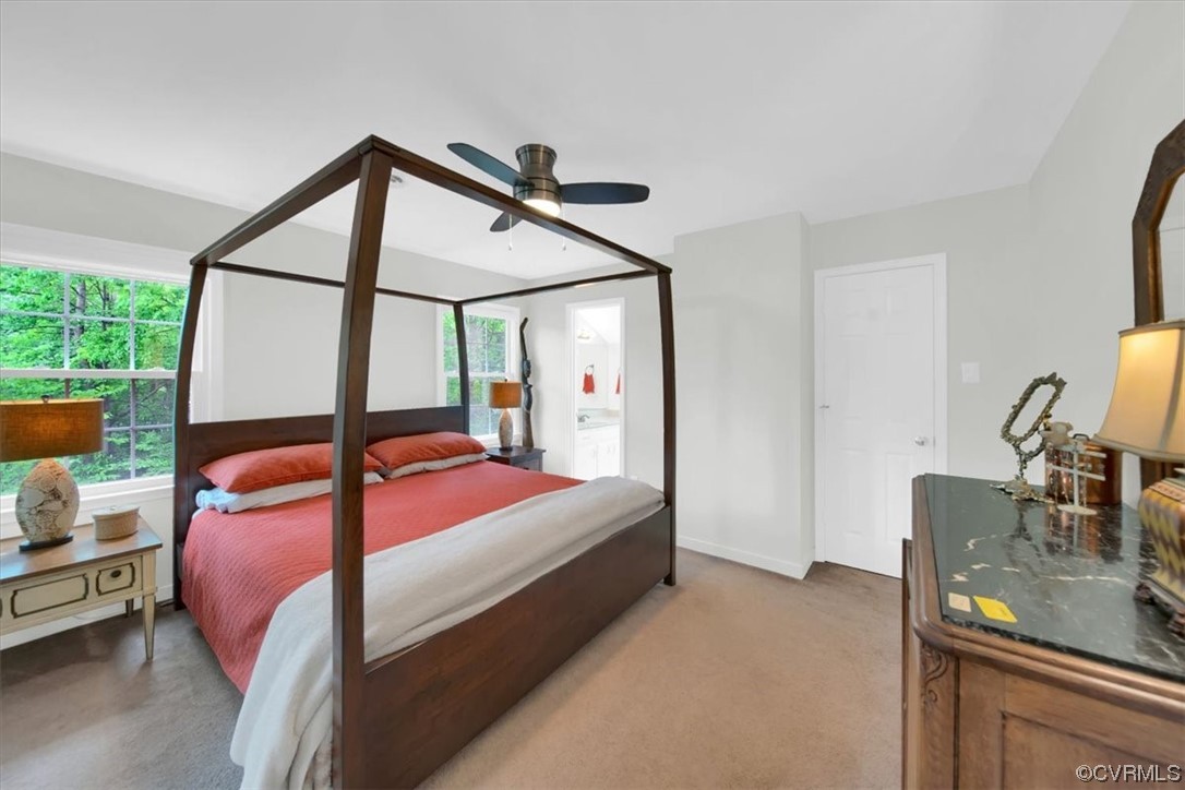 7121 Pointer Ridge Road Midlothian, VA 23112 - Photo 39 of 50 a bedroom with a bed a dresser and windows