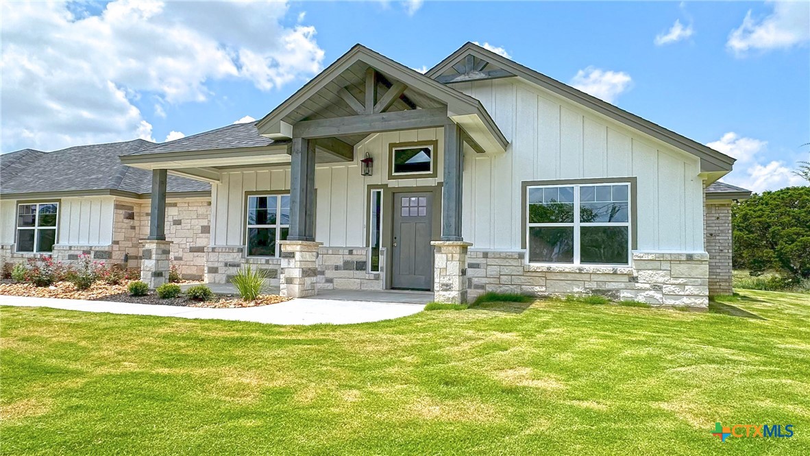a front view of a house with swimming pool and garden