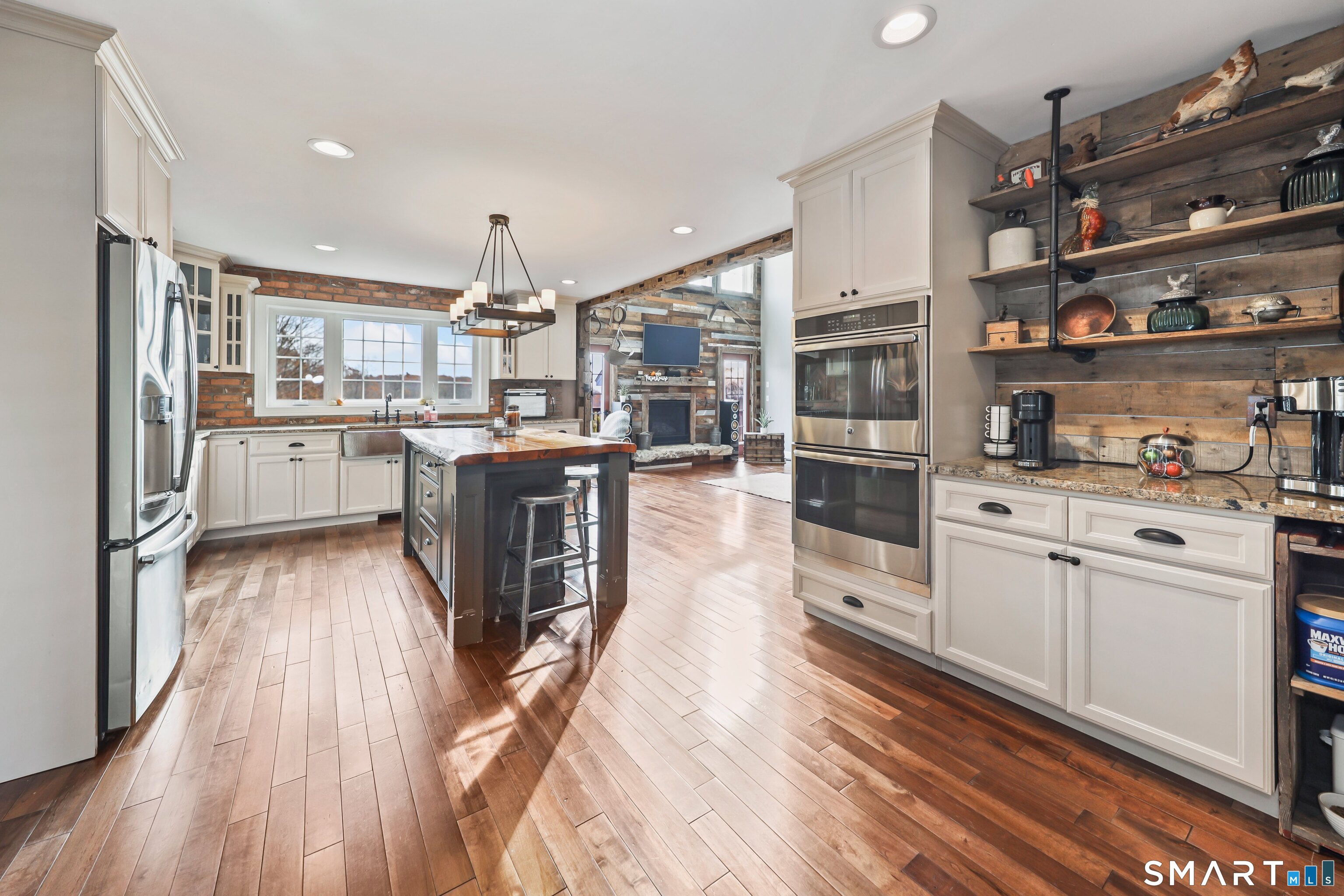195 Hinman Road Watertown, CT 06795 - Photo 11 of 39 a kitchen with stainless steel appliances granite countertop lots of counter top space and wooden floors