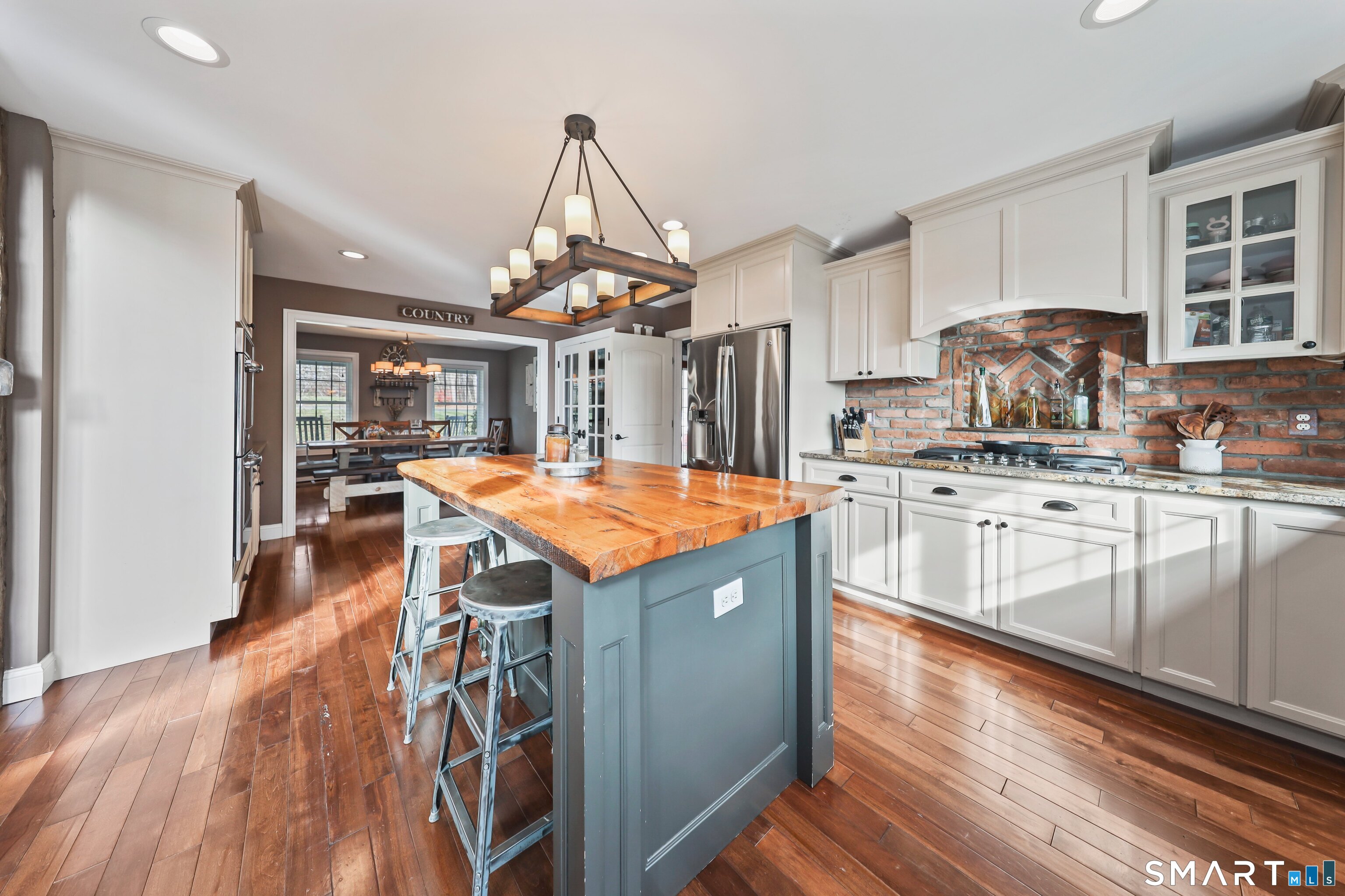 195 Hinman Road Watertown, CT 06795 - Photo 14 of 39 a kitchen with stainless steel appliances granite countertop a sink a stove and a wooden floors