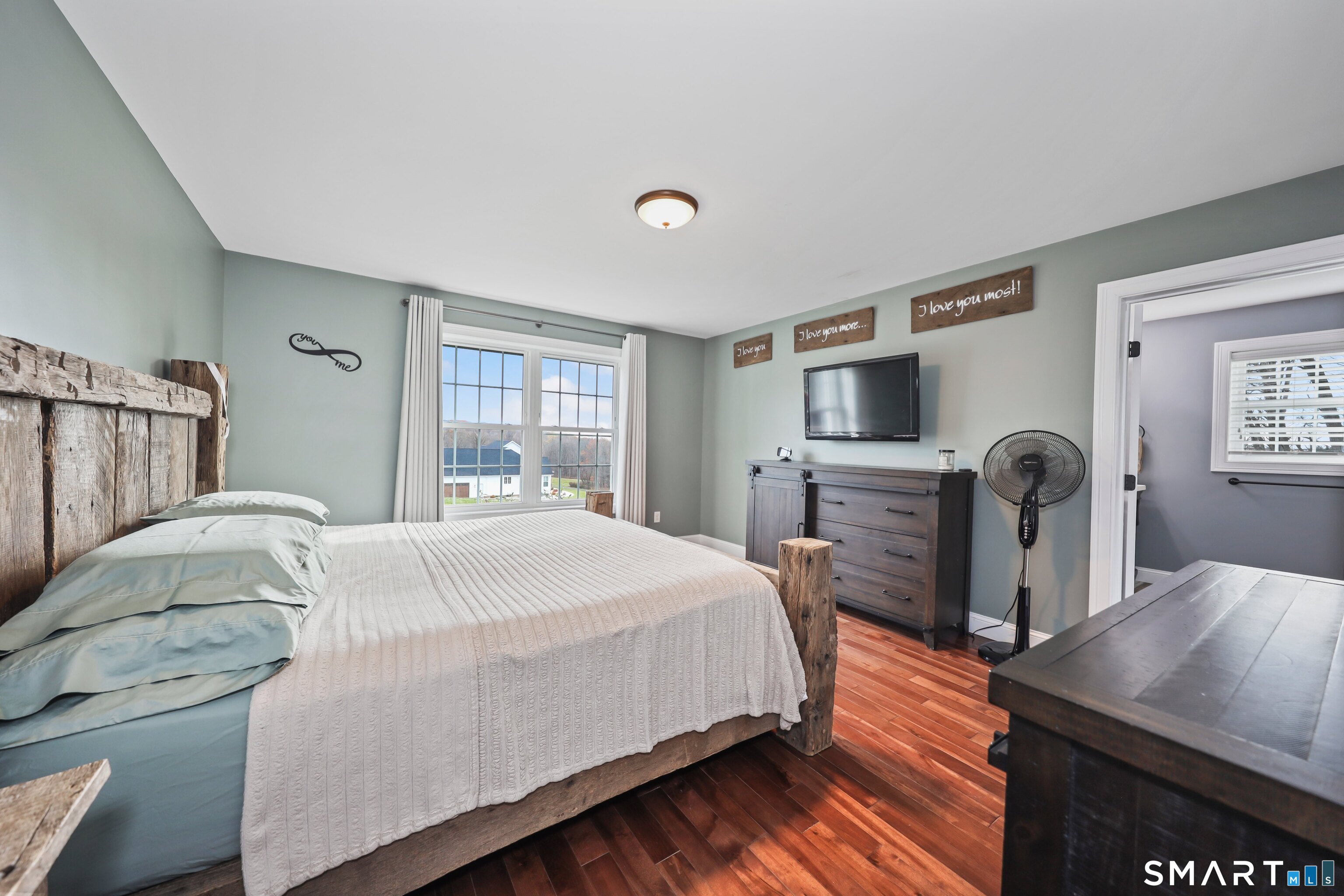 195 Hinman Road Watertown, CT 06795 - Photo 28 of 39 a bedroom with a bed and wooden floor