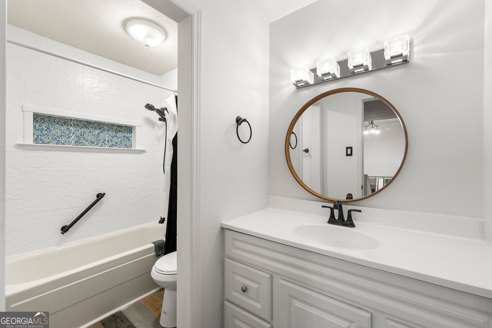 1820 Ashborough Road Southeast, Unit B Marietta, GA 30067 - Photo 17 of 21 a bathroom with a toilet a sink and a mirror