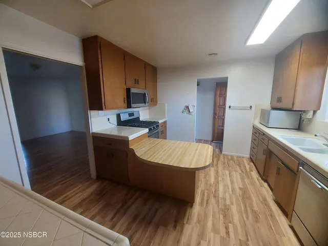 a room with a sink and a stove top oven