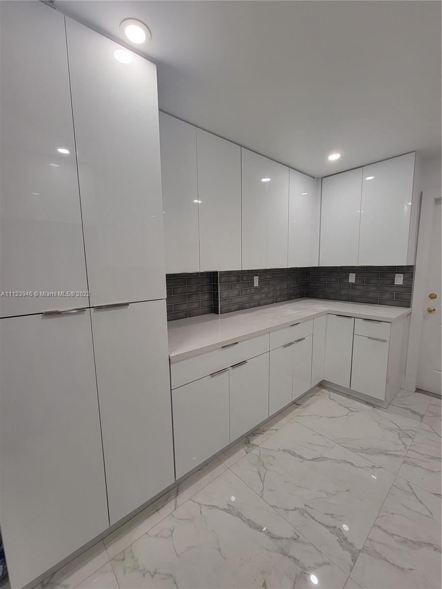 6501 Southwest 34th Street Miami, FL 33155 - Photo 15 of 62 a kitchen with white cabinets