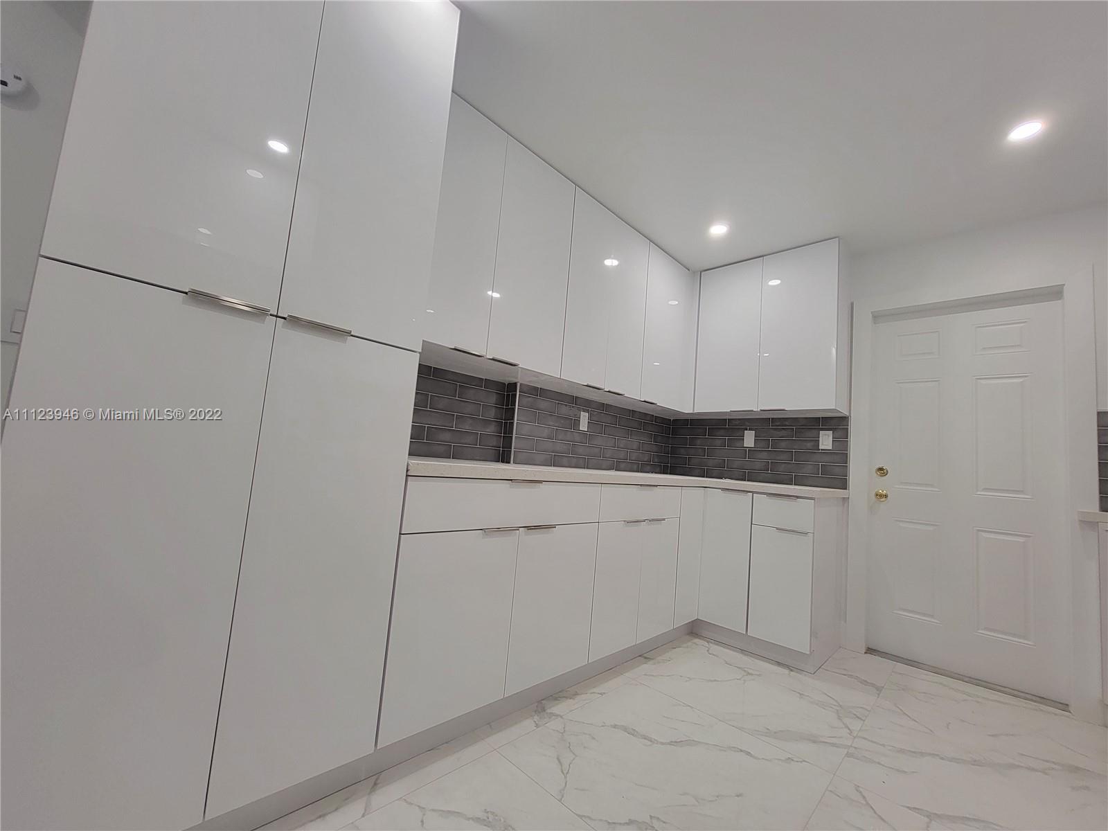 6501 Southwest 34th Street Miami, FL 33155 - Photo 17 of 62 a kitchen with white cabinets and white appliances