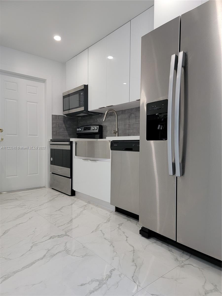 6501 Southwest 34th Street Miami, FL 33155 - Photo 18 of 62 a kitchen with stainless steel appliances a refrigerator sink and microwave
