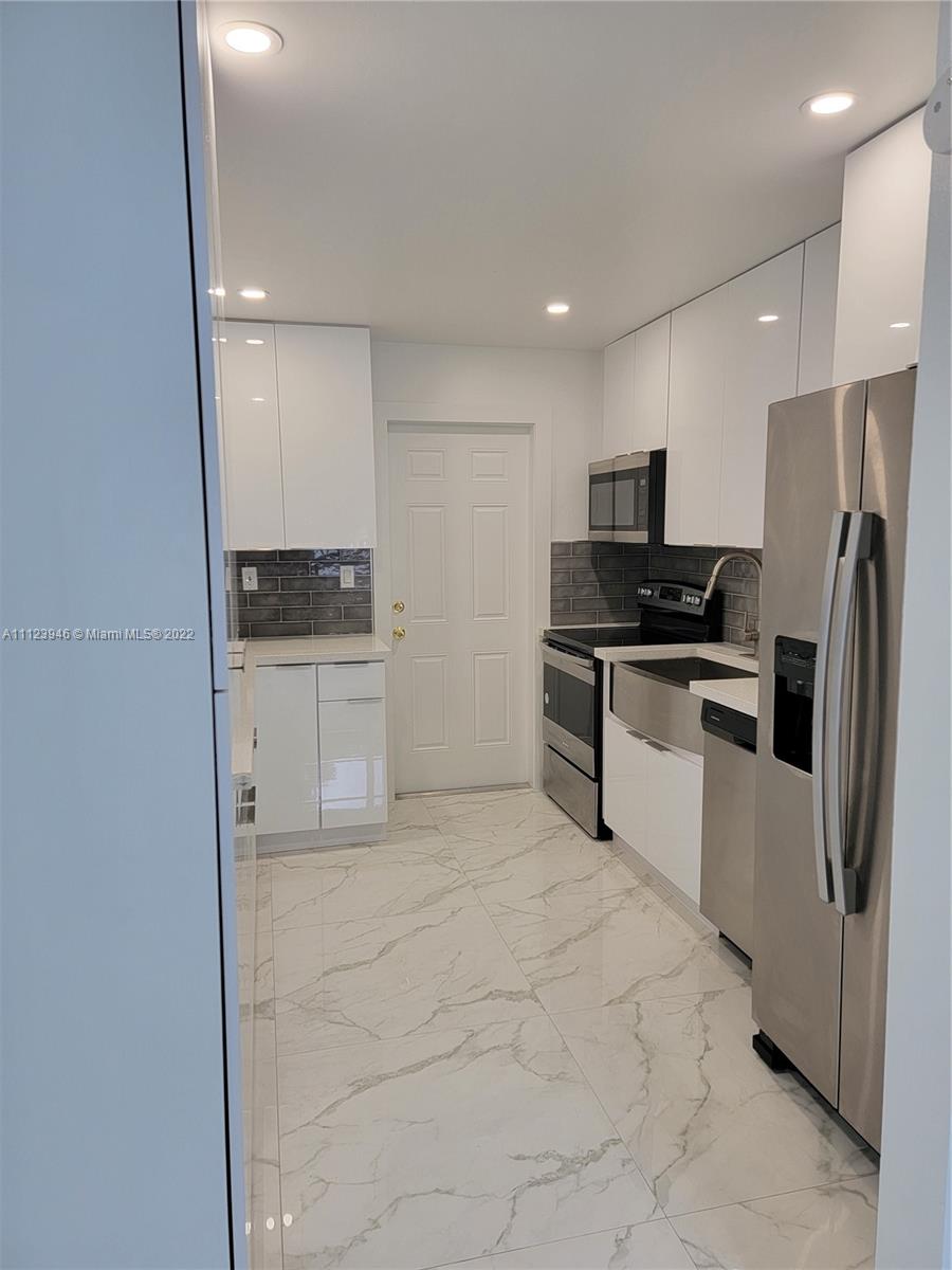 6501 Southwest 34th Street Miami, FL 33155 - Photo 19 of 62 a kitchen with stainless steel appliances a refrigerator and a stove top oven