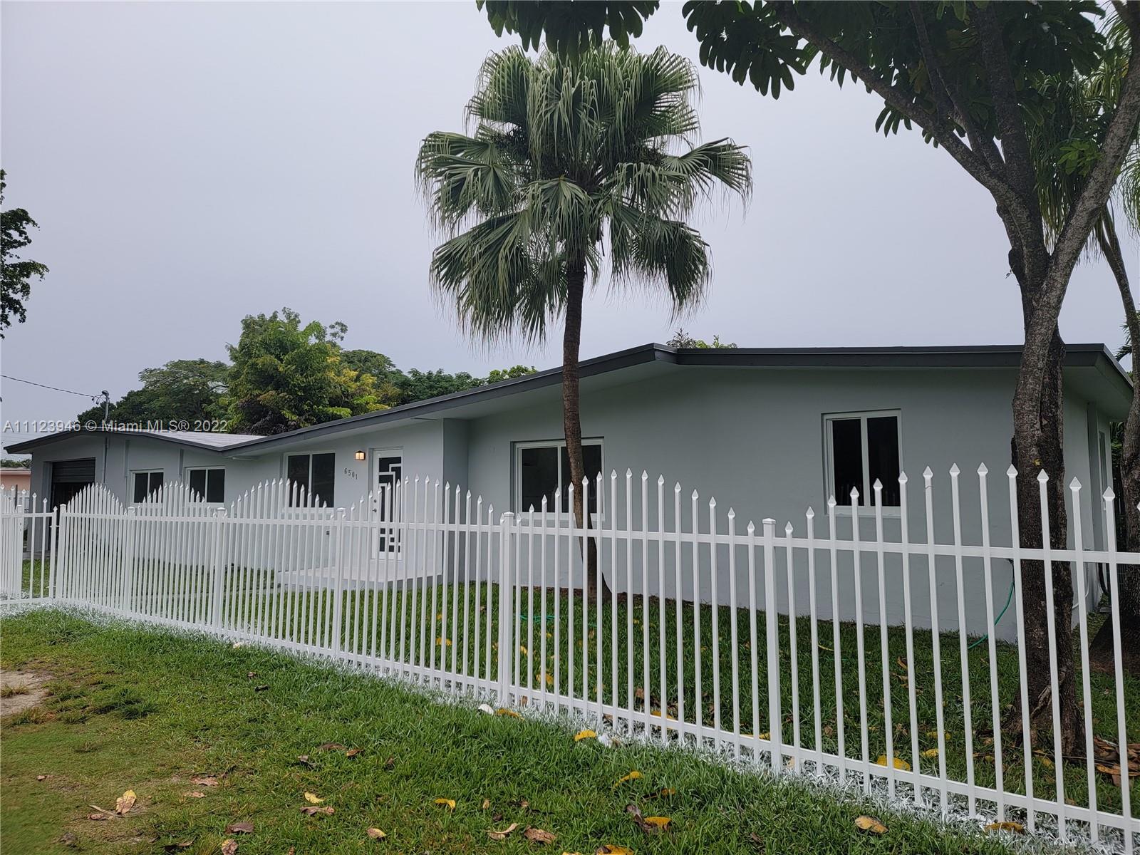 6501 Southwest 34th Street Miami, FL 33155 - Photo 2 of 62 a front view of a house with a garden