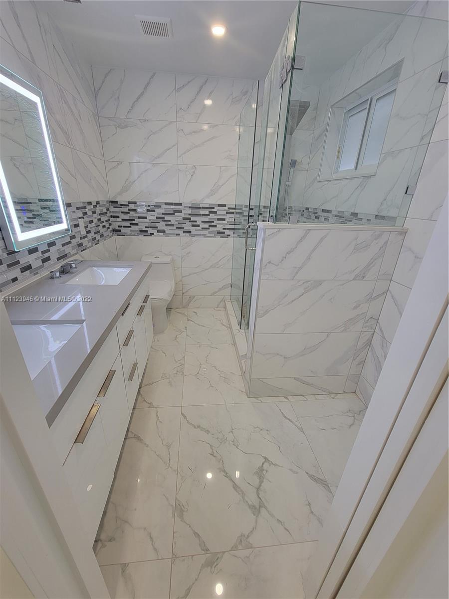 6501 Southwest 34th Street Miami, FL 33155 - Photo 24 of 62 a bathroom with a sink a toilet and a mirror
