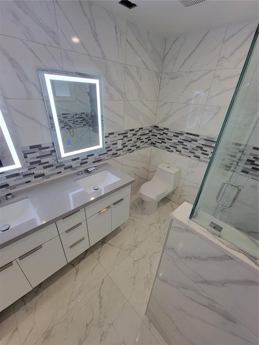 6501 Southwest 34th Street Miami, FL 33155 - Photo 25 of 62 a bathroom with a sink and mirror