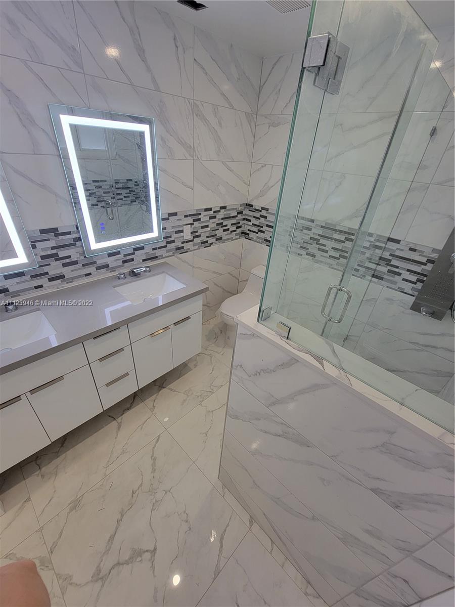 6501 Southwest 34th Street Miami, FL 33155 - Photo 28 of 62 a bathroom with a granite countertop sink and a mirror
