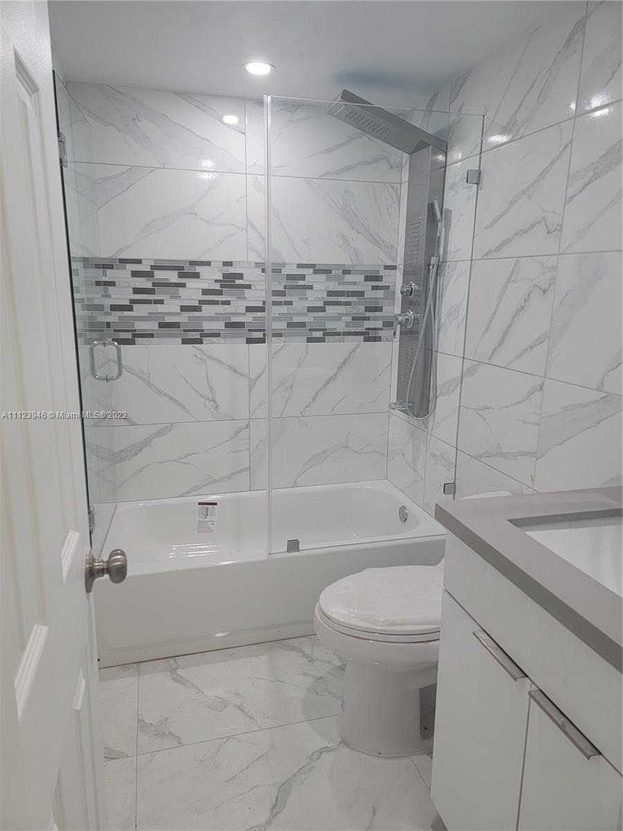 6501 Southwest 34th Street Miami, FL 33155 - Photo 30 of 62 a bathroom with a bathtub shower sink vanity and toilet