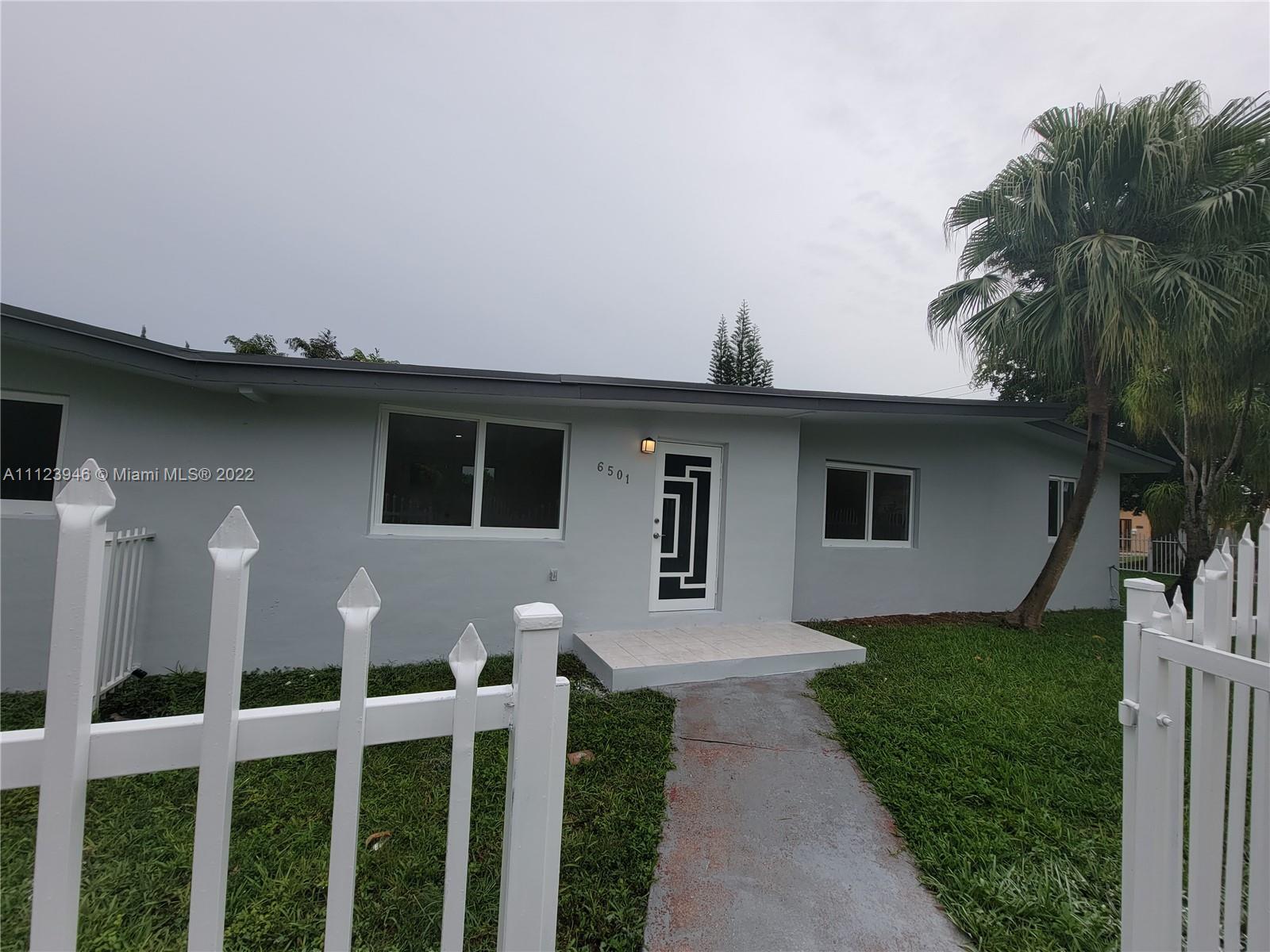6501 Southwest 34th Street Miami, FL 33155 - Photo 5 of 62 a front view of a house with a yard