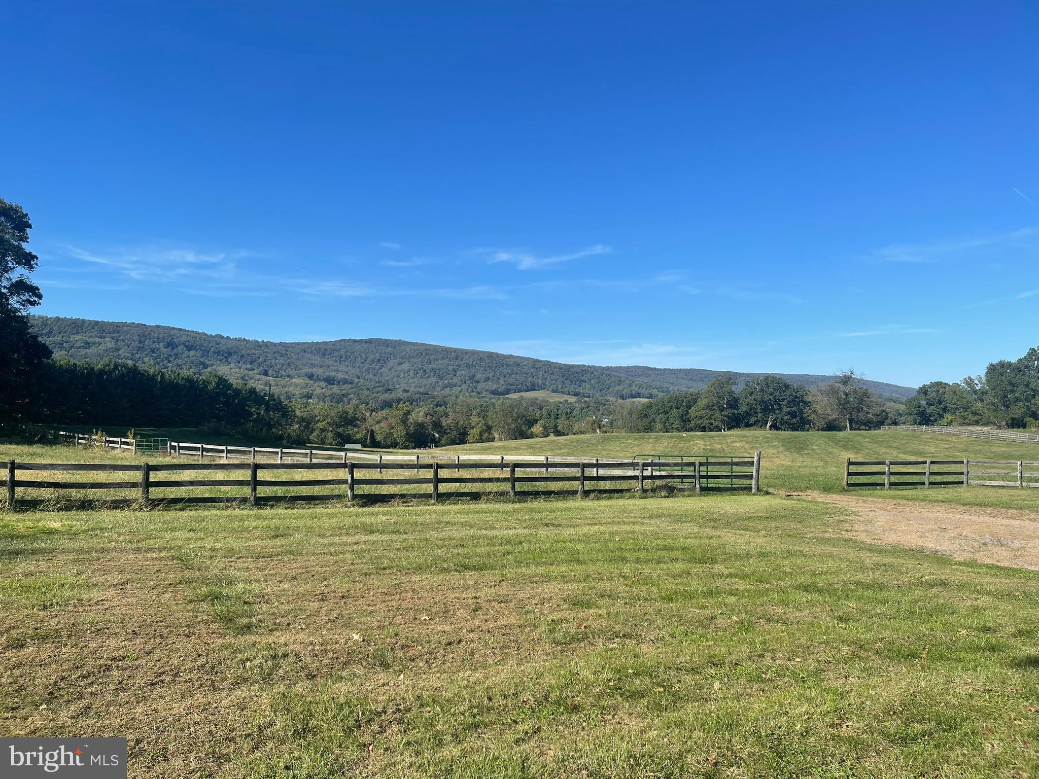 1079 Greystone Road Upperville, VA 20184 - Photo 2 of 21 a view of a lake with houses in the back