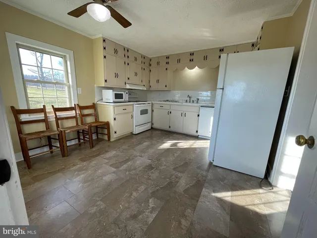 a view of kitchen with furniture and wooden floor