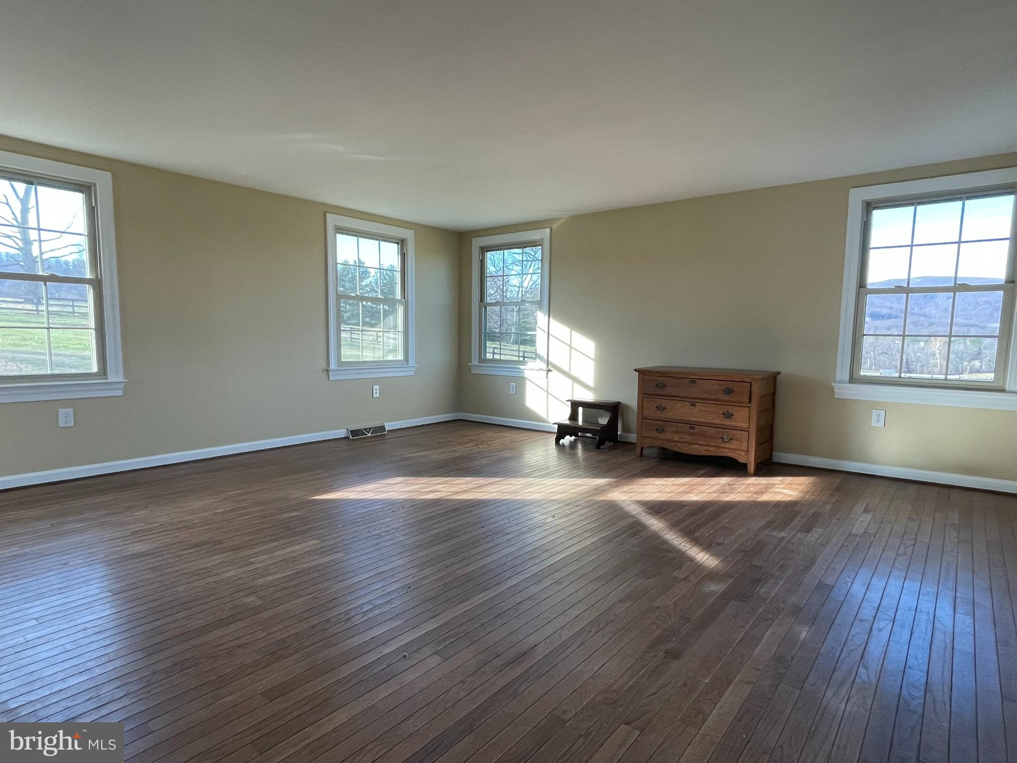 1079 Greystone Road Upperville, VA 20184 - Photo 9 of 21 a view of empty room with wooden floor and fan