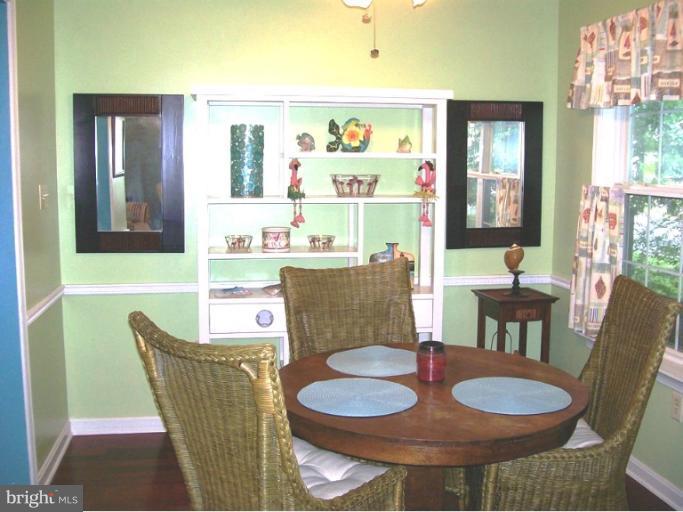 1544 Elm Road St. Leonard, MD 20685 - Photo 1 of 17 a dining room with furniture and a wooden floor