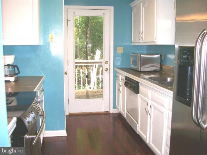 1544 Elm Road St. Leonard, MD 20685 - Photo 13 of 17 a kitchen with a sink a stove and refrigerator