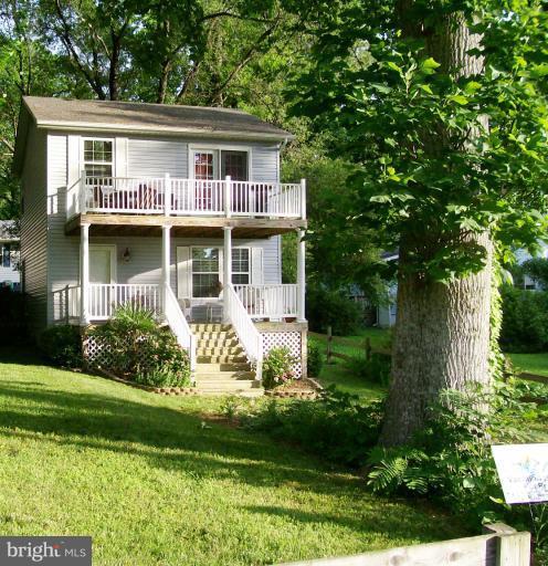 1544 Elm Road St. Leonard, MD 20685 - Photo 17 of 17 a front view of a house with a yard and potted plants