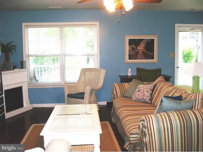 1544 Elm Road St. Leonard, MD 20685 - Photo 6 of 17 a living room with furniture a large window and a fireplace