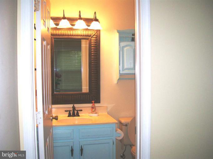 1544 Elm Road St. Leonard, MD 20685 - Photo 9 of 17 a bathroom with a sink and a mirror