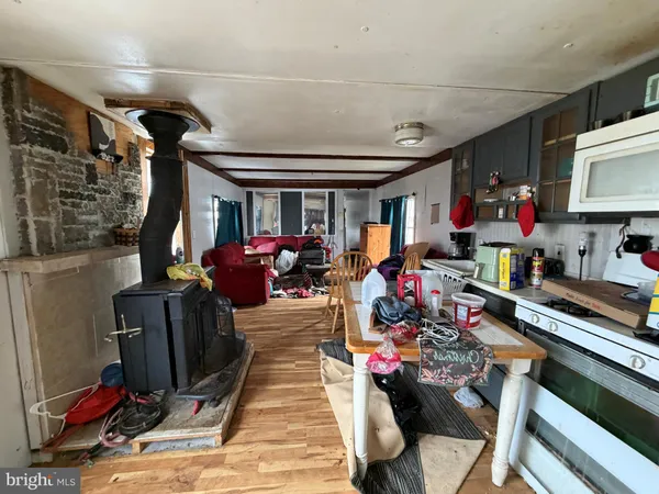 a kitchen with a refrigerator a stove and a dining table