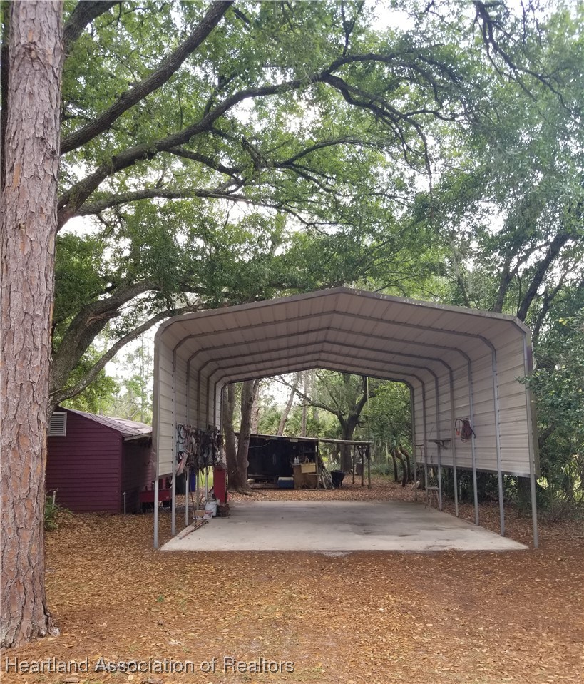 9125 Spur Path Sebring, FL 33875 - Photo 23 of 31 Large motorhome carport w/concrete floor (when empty)