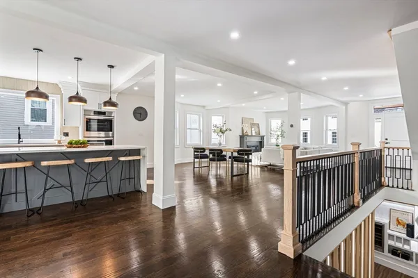 a large white kitchen with lots of counter space and stainless steel appliances
