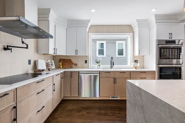 a kitchen with a sink stove and cabinets