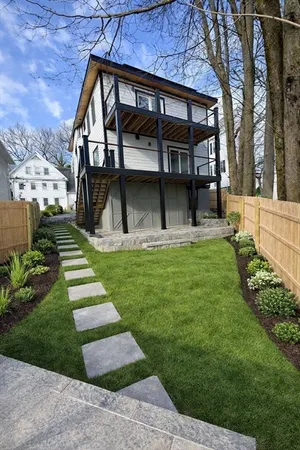 a front view of a house with a yard and trees