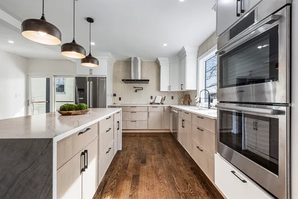 a kitchen with stainless steel appliances a stove a sink and a refrigerator