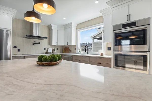 a kitchen with stainless steel appliances a stove a sink and a microwave