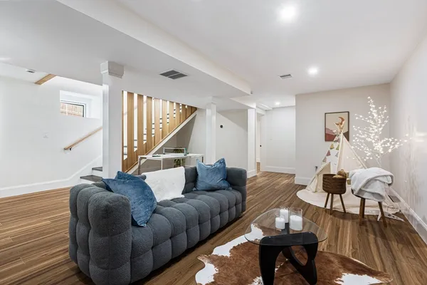 a living room with furniture and a wooden floor
