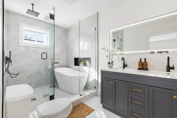 a bathroom with a sink a toilet and shower