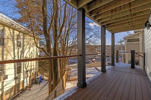 a view of a balcony with wooden floor