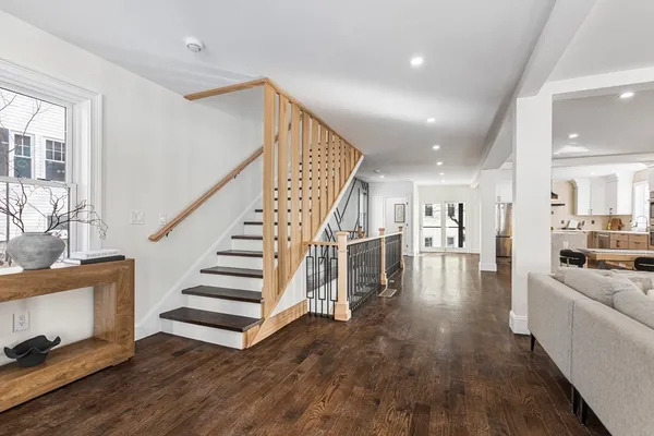 a view of entryway and hall with wooden floor
