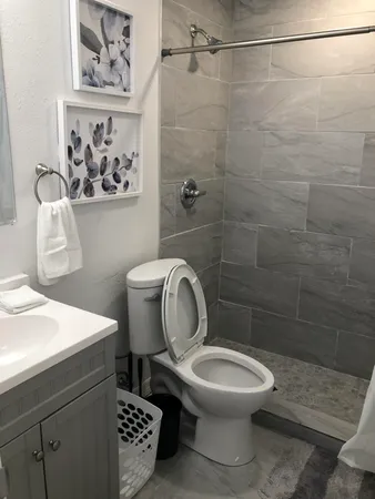 a bathroom with a toilet a sink and a shower