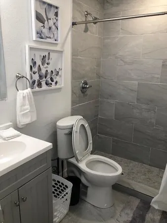 a bathroom with a toilet sink and shower