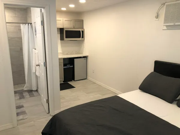 a bedroom with a bed and a television