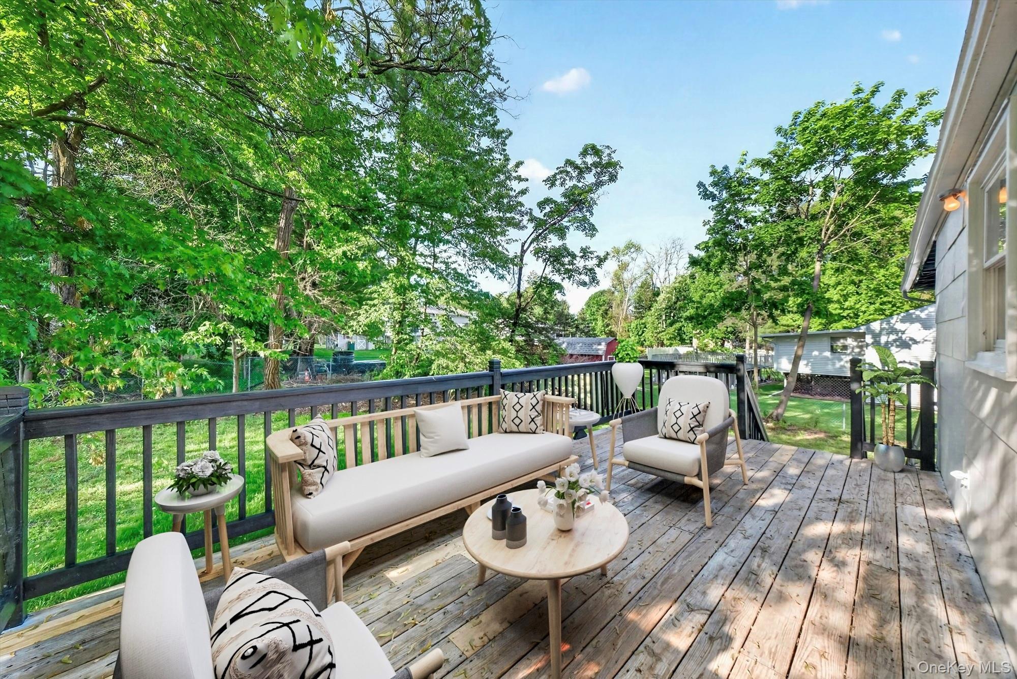 8 Mockingbird Lane Poughkeepsie, NY 12601 - Photo 22 of 32 Virtually Staged. Step outside to the deck, a great space for morning coffee, outdoor dining, grilling, or simply relaxing while enjoying the backyard setting.