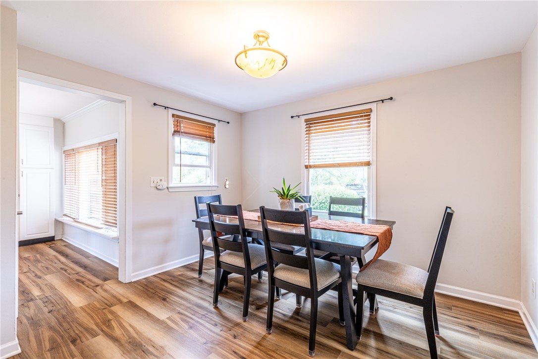 6432 Lakeside Road Ontario, NY 14519 - Photo 10 of 35 Rich wood-look flooring and generous windows define this welcoming dining area.