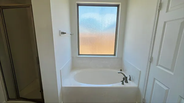 a white bath tub sitting next to a window